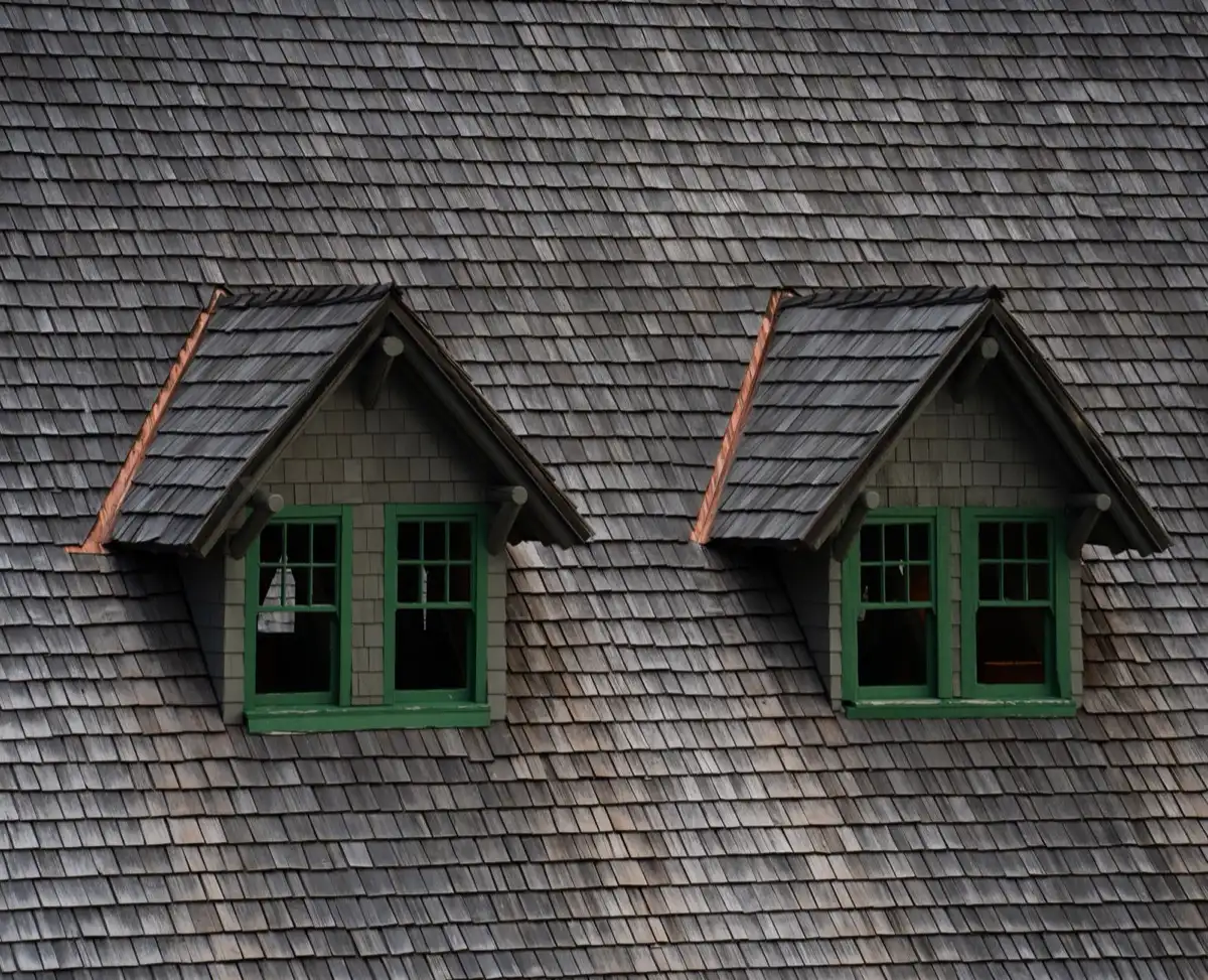 Dormers on a shingle roof in Madison, AL, where step flashing and kickout flashing carry water past the walls